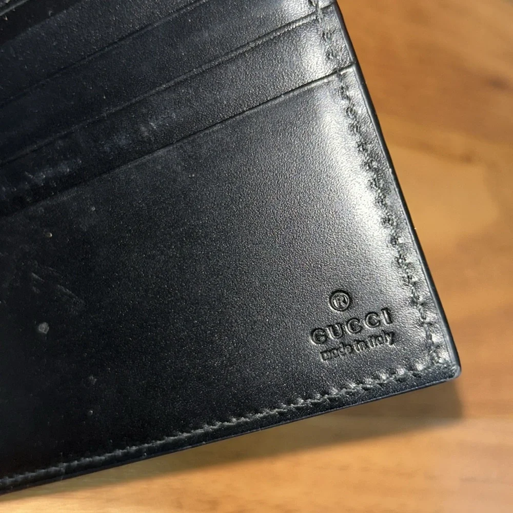 Authentic Gucci Dorian Signature Embossed Leather Bifold Wallet